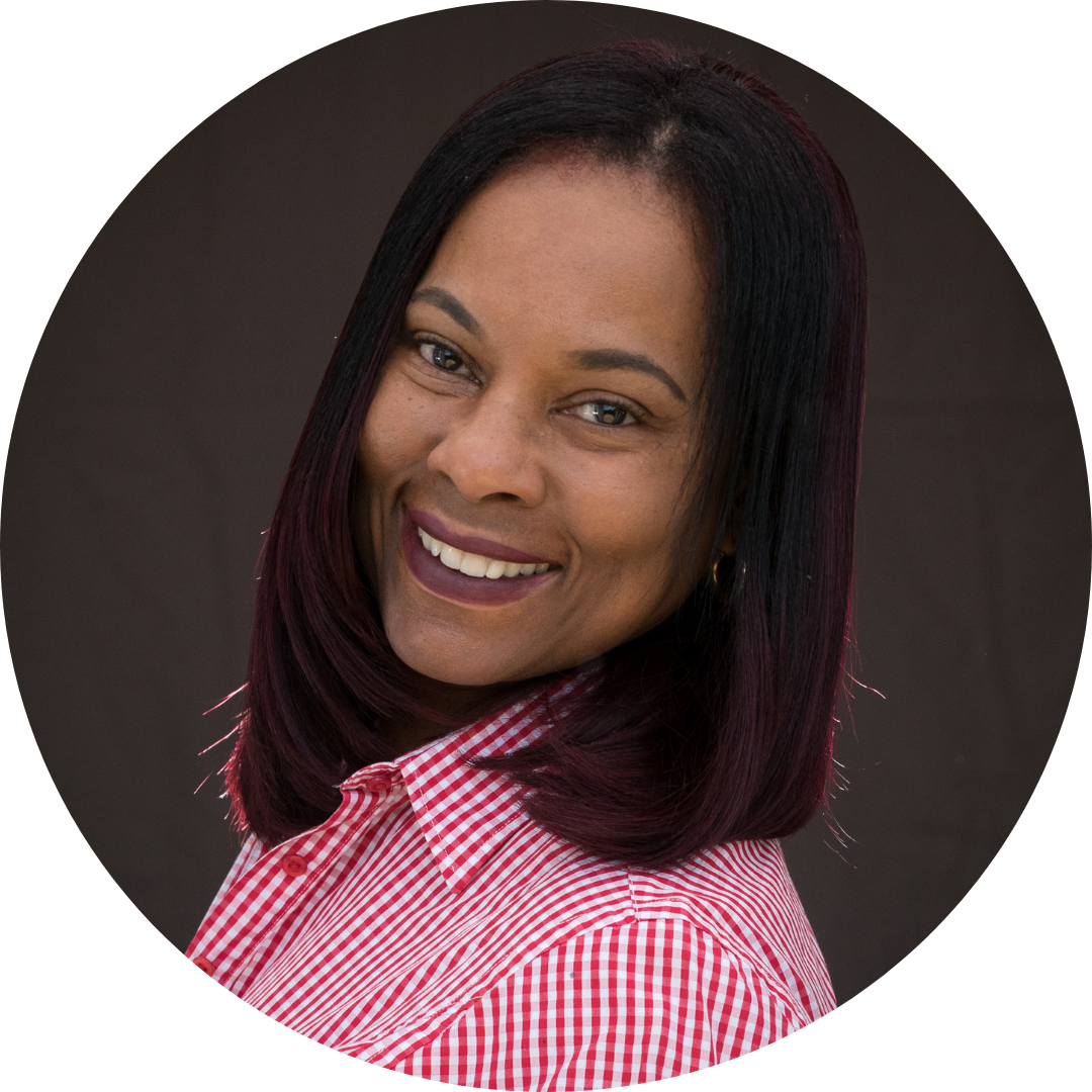 An image of Melanie Williams Browne. She is smiling at the camera and wearing a pink shirt.